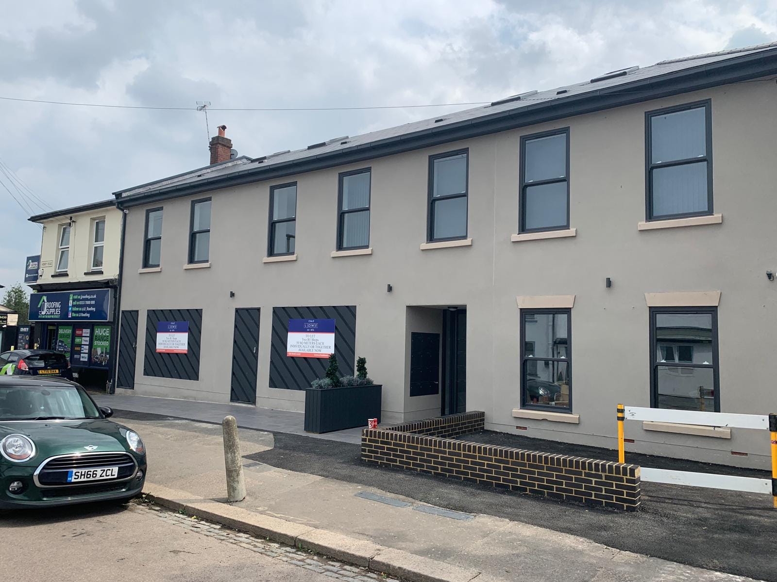 Completed light grey lime render finish on a commercial or residential building in the London area.