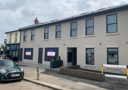 Completed light grey lime render finish on a commercial or residential building in the London area.